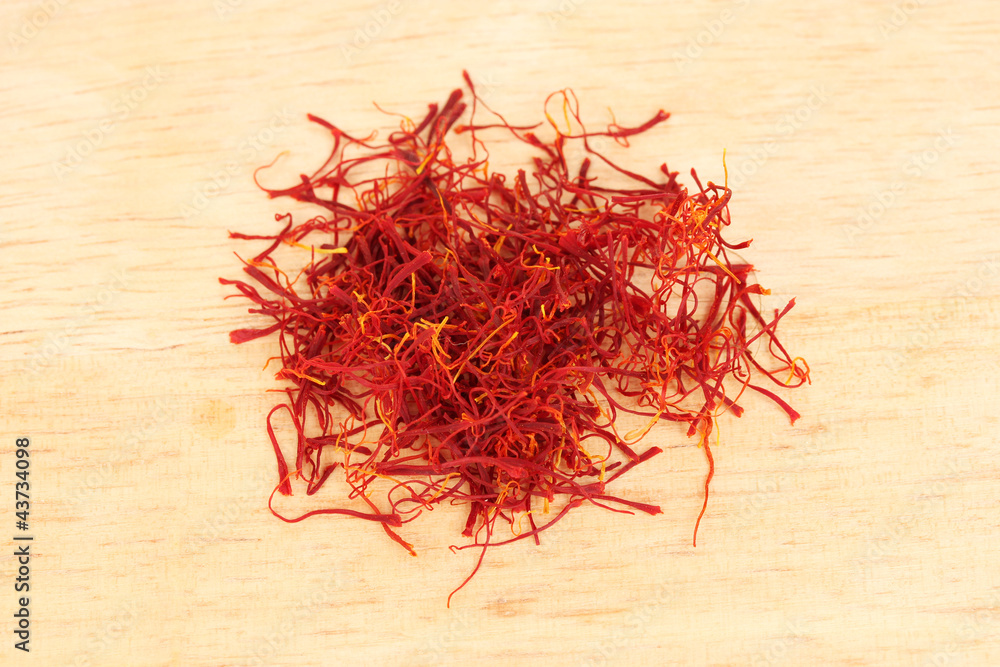 Fototapeta premium stigmas of saffron on wooden background close-up