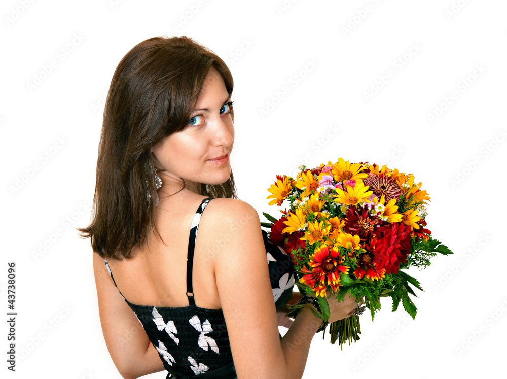 Young woman holding a bouquet or flowers standing back to camera