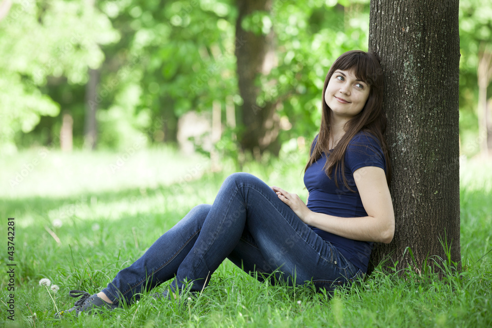Young fashion girl with headphones at green spring grass. Young fashion girl with headphones at green spring grass.