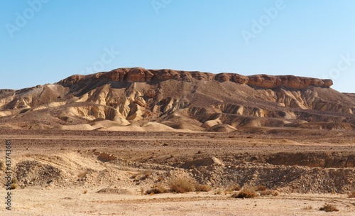 Scenic weathered yellow hill in stone desert