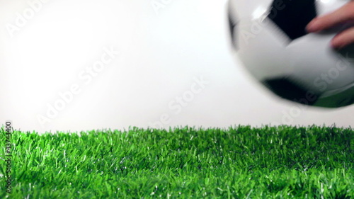 Soccer ball in motion on the green grass.