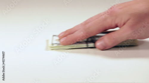 One hand gives money to another hand, close up