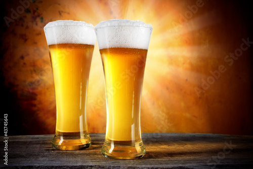 Beer in a glasses with gold background