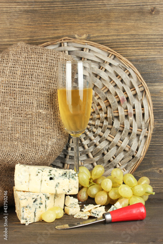 composition of blue cheese and a glass of wine with grapes