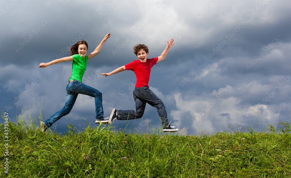 Girl and boy jumping, running outdoor Girl and boy jumping, running outdoor