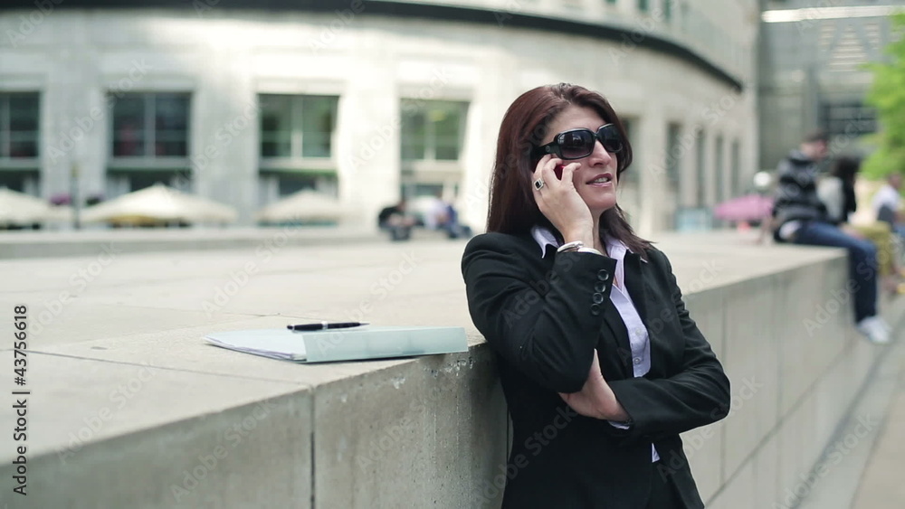 Young businesswoman talking on cellphone in the city Young businesswoman talking on cellphone in the city