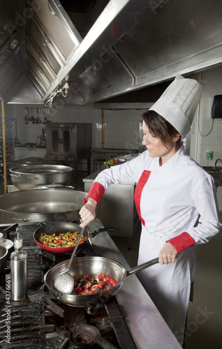 portrait of mid adult female chef in kitchen 