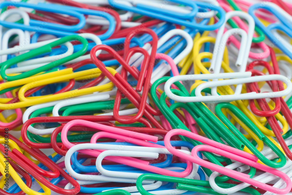 Colorful paper clip on white background close up Colorful paper clip on white background close up