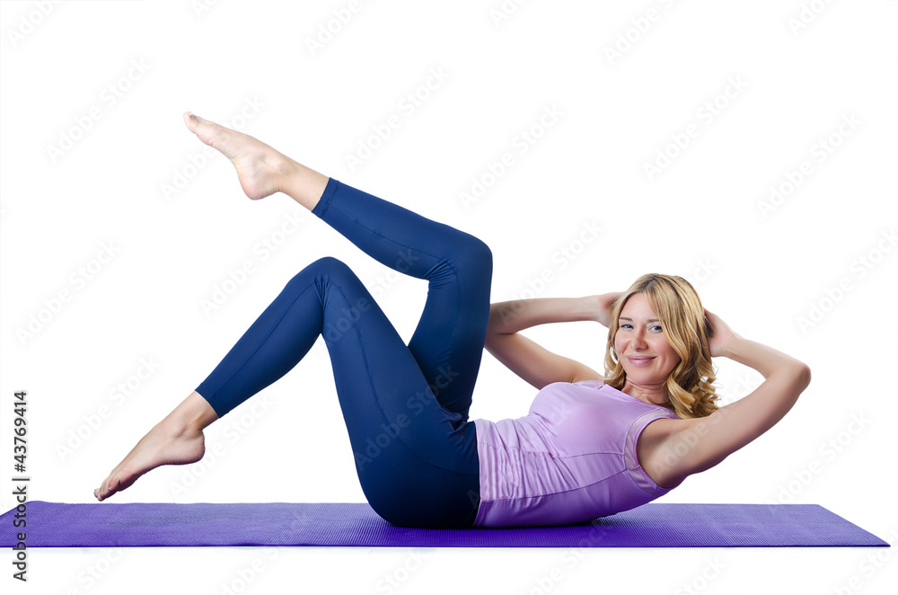 Female sportsman doing exercises on white Female sportsman doing exercises on white