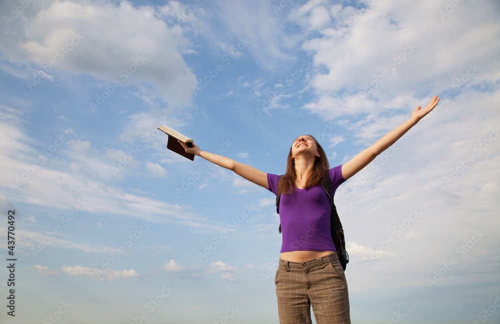 Young woman staying with raised hands
