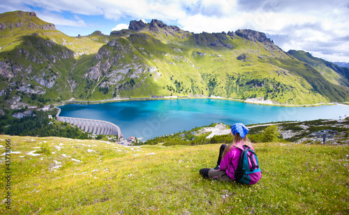 cute girl standing on a hill looking at a beautiful scenary