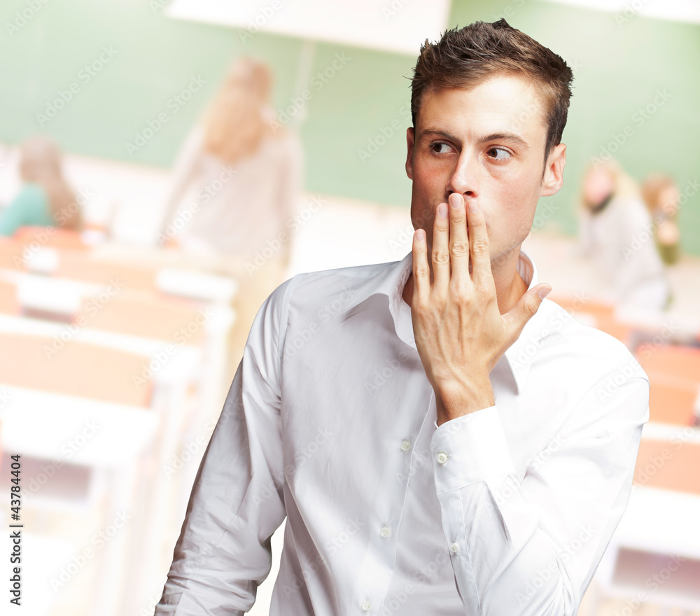 Portrait Of Young Man Covering His Mouth Portrait Of Young Man Covering His Mouth