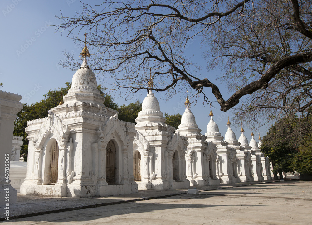 white and golden stupa in buddhist temple