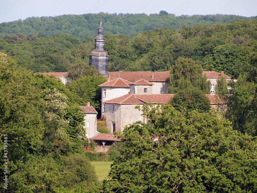 Old village of Mortemart and its leaning bell tower surrounded by the forest, France, Limousin
