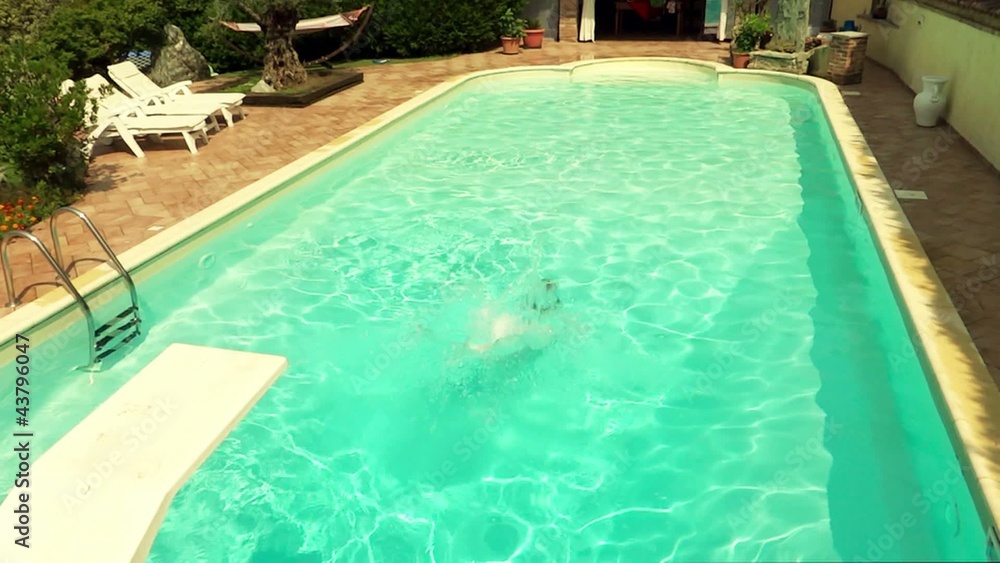 boy diving and swimming into pool boy diving and swimming into pool