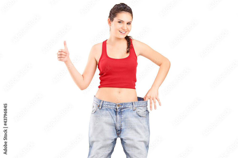 A weightloss girl giving a thumb up A weightloss girl giving a thumb up