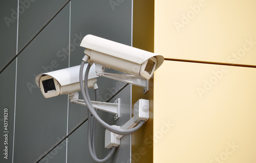 Two CCTV cameras on the cone of the morden building