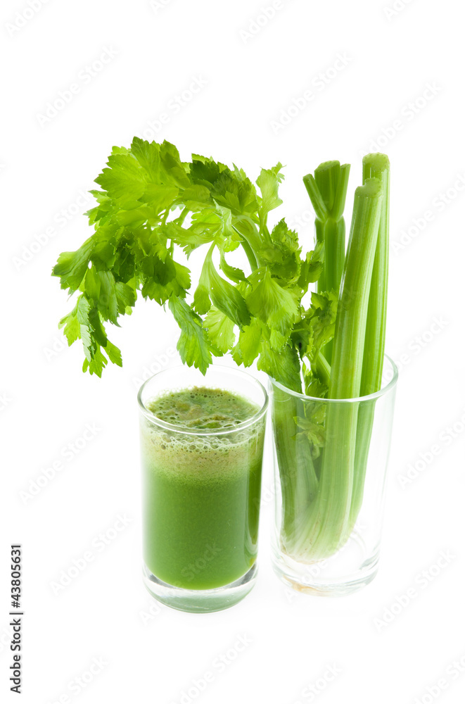 Pure fresh green celery juice in glass isolated on white backgro Pure fresh green celery juice in glass isolated on white backgro