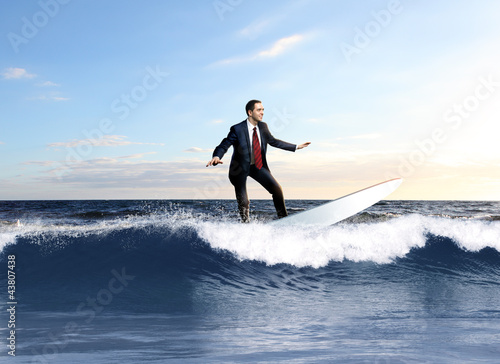 Fotografie, Obraz Young business person surfing on the waves