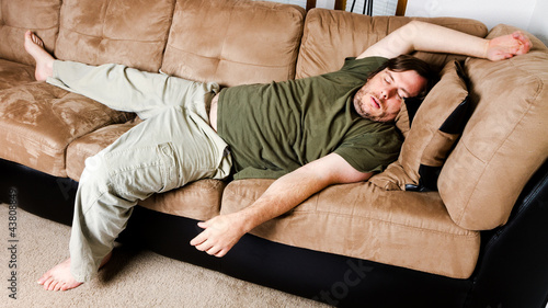 Fotografie A guy flung all over the couch