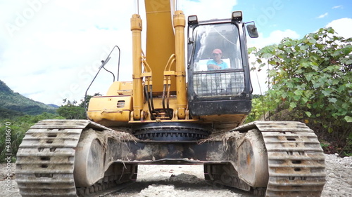 Heavy equipment excavator running over the camera or viewer.