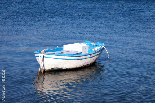 Blue and white old wood boat at a Mediterranean sea(Greece) © Inna Felker