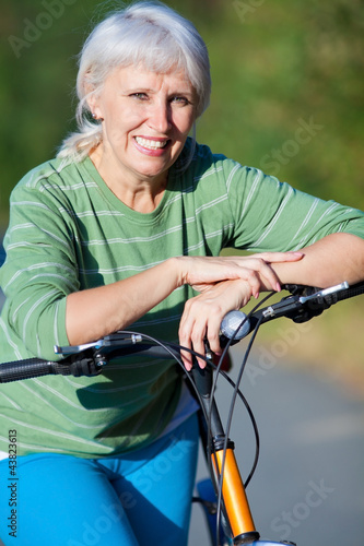 mature woman with bicycle © yanlev