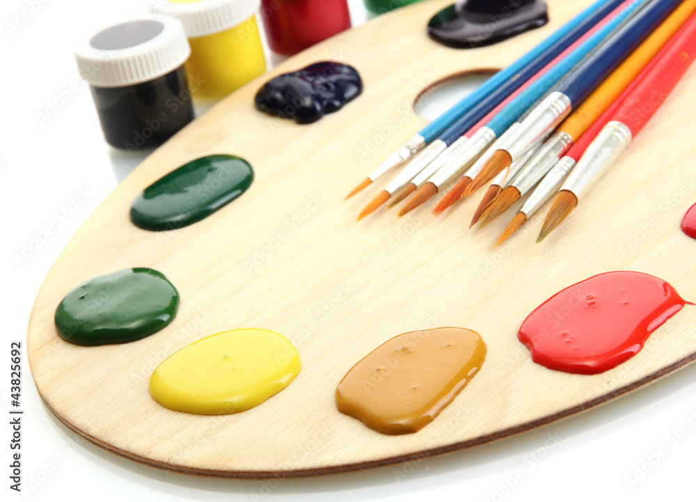 wooden art palette with paint and brushes.isolated on white wooden art palette with paint and brushes.isolated on white
