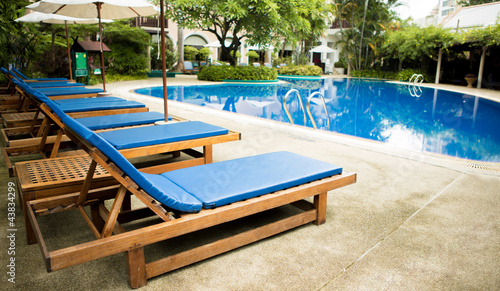 Swimming pool with relaxing seats © jannoon028