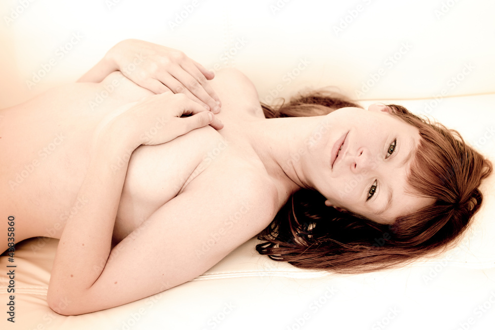 Naklejka premium naked woman on a sofa
