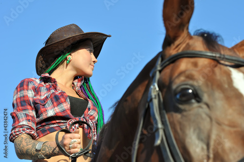 young tattooed stylish woman riding in summer day © beerfan