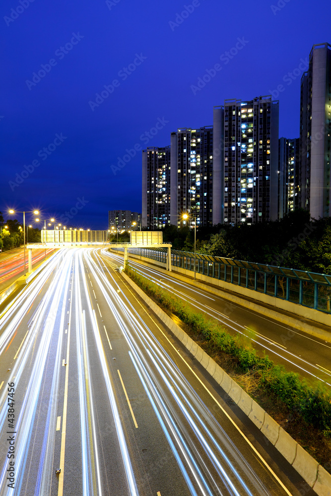 traffic with blur light through city at night