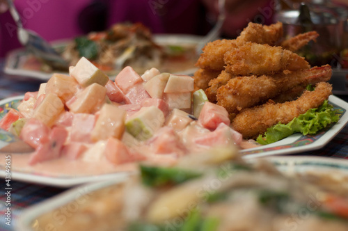 fried shrimp and fruit salad on dishes