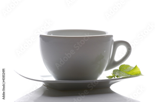 tea cup and a mint leaf
