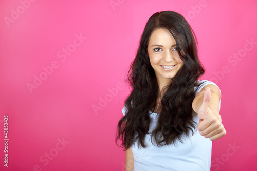 beautiful young smiling girl against pink background