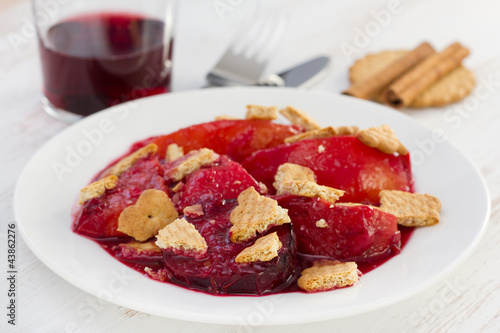 baked fruits with cookies on the white plate