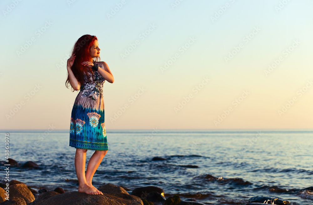 girl on seacoast before a sunset