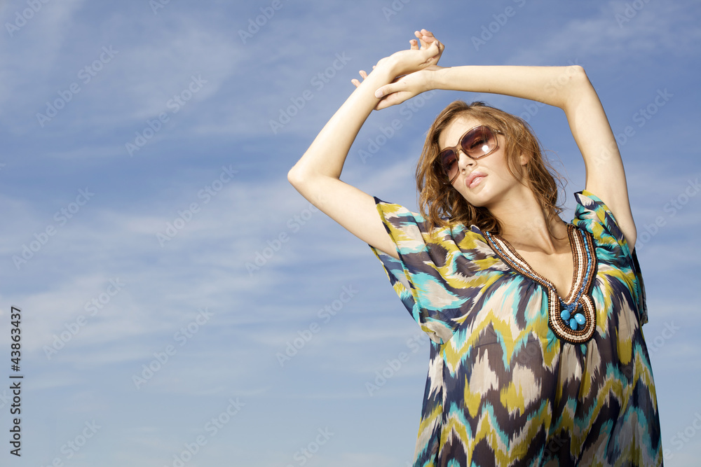 beautiful girl in sunglasses on background blue sky beautiful girl in sunglasses on background blue sky