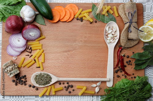 Frame made of spices and vegetables on a wooden table.