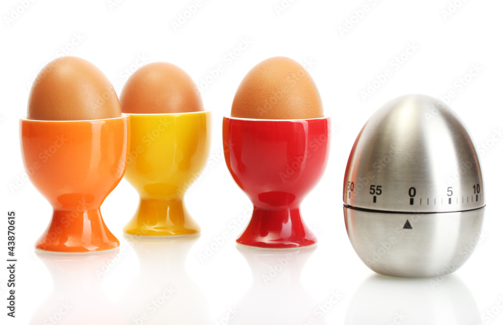 egg timer and egg in color stand isolated on white egg timer and egg in color stand isolated on white