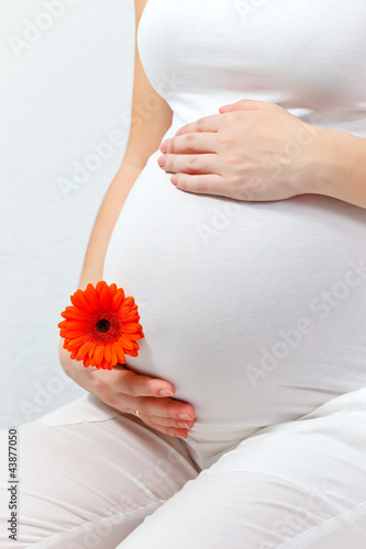 Pregnant woman touching here belly