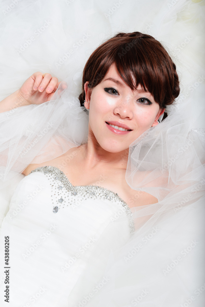 bride sitting in wedding dress, studio shot