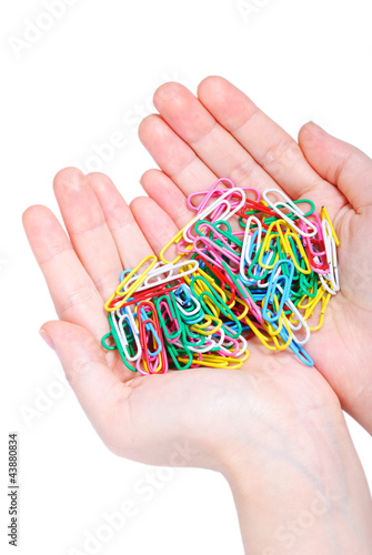 Hands full of paper clips