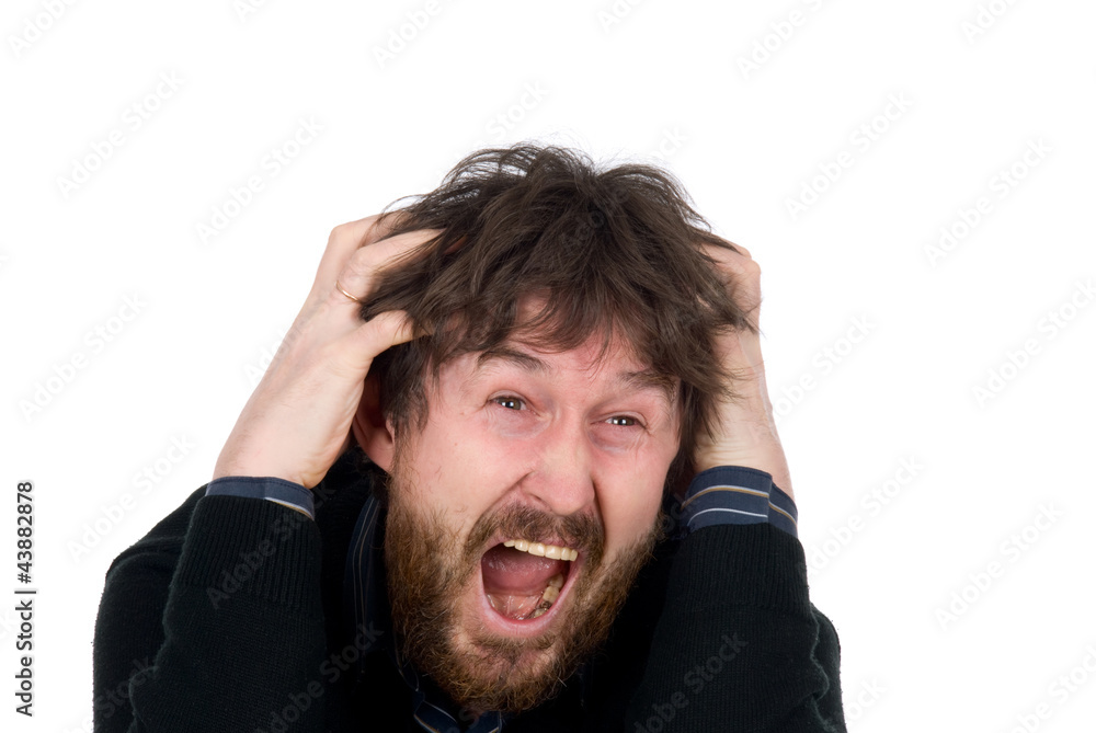 Man with a beard shouts and holds hands head Man with a beard shouts and holds hands head