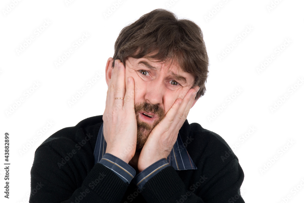Portrait of upset man with hands on cheeks Portrait of upset man with hands on cheeks