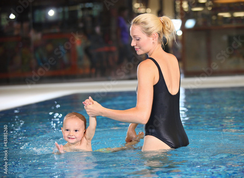 Young cheerful mother and little son in a swimming pool © Andrey Bandurenko