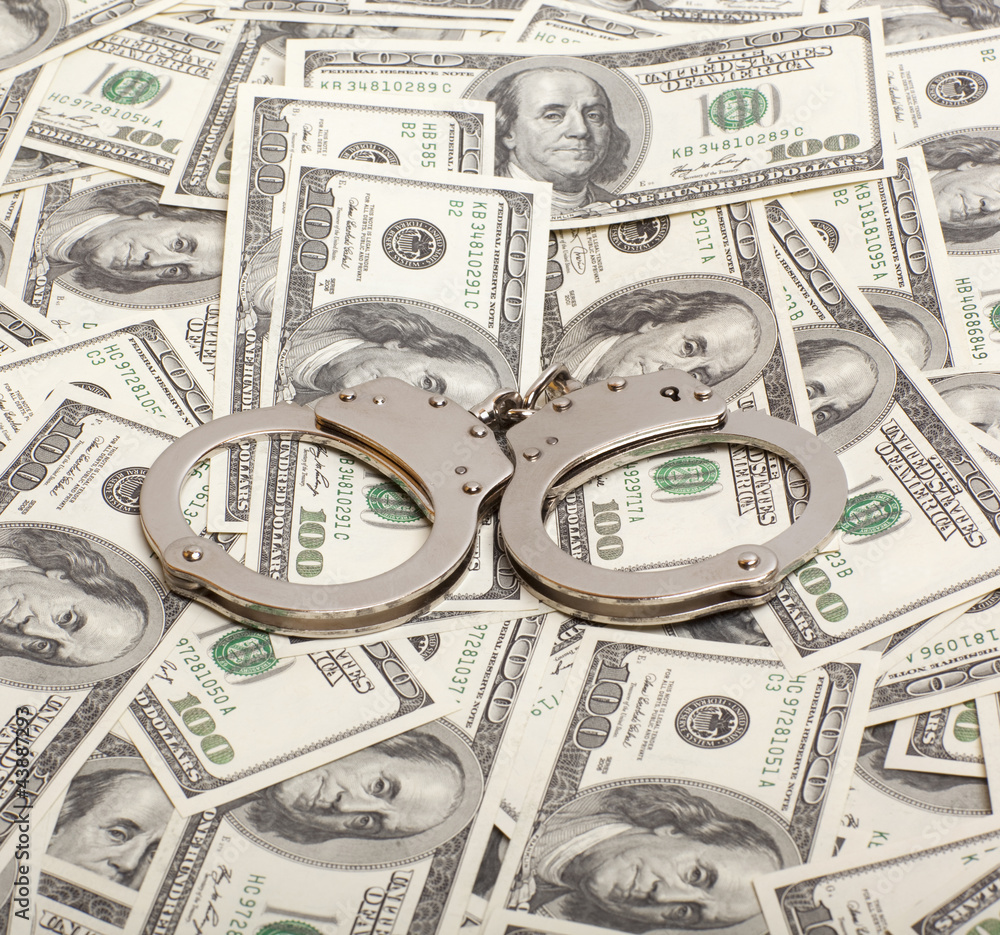 Handcuffs on money background Criminal concepts Handcuffs on money background Criminal concepts