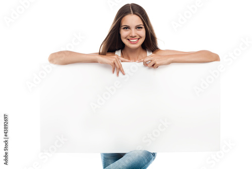 Beautiful woman holding a blank billboard