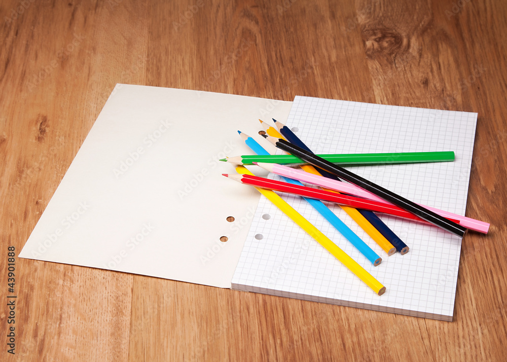 pencils and notebook on wooden table pencils and notebook on wooden table