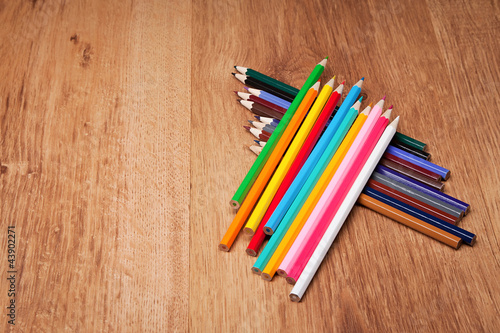 Assortment of colored pencils on wooden table